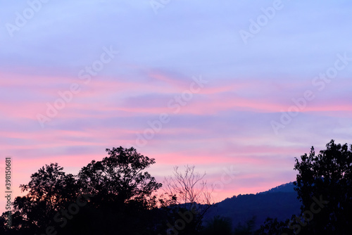 Beautiful twilight sky with cloud after sunset above the hill and trees © nungning20