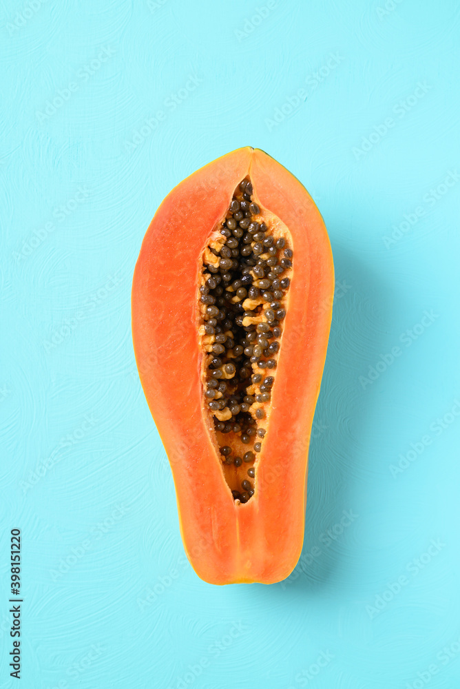 Half ripe papaya fruit on pastel color background, Tropical fruit, Top view Half ripe papaya fruit on pastel color background, Tropical fruit, Top view