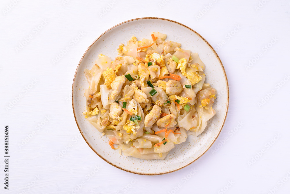 Thai food (Kuaitiao Khua Kai), Stir fried rice noodles with egg and chicken on white background Thai food (Kuaitiao Khua Kai), Stir fried rice noodles with egg and chicken on white background