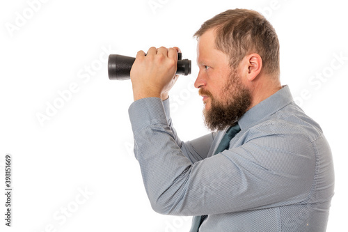 Soilid bearded man in shirt with binoculars photo