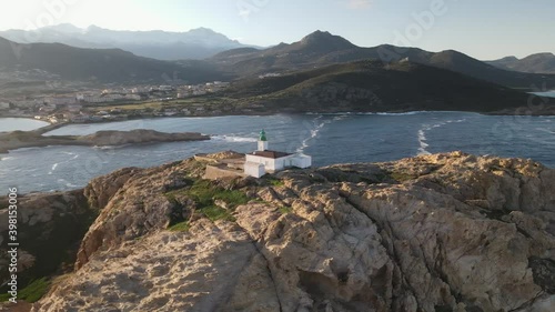 Aerial view circling the lighthouse on La Pietra, the red rock, at Ile Rousse in the Balagne region of Corsica photo