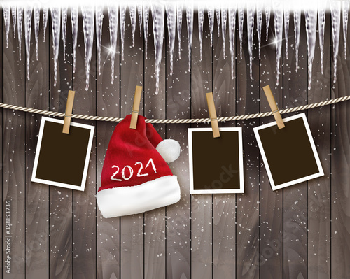 Merry Christmas and New Year Holiday background with photos and a santa hat with 2021 on the rope. Vector.
