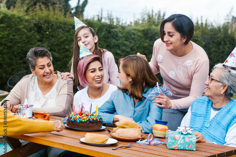 Fototapeta premium hispanic Family happy birthday celebration garden party outside in the backyard in Mexico City