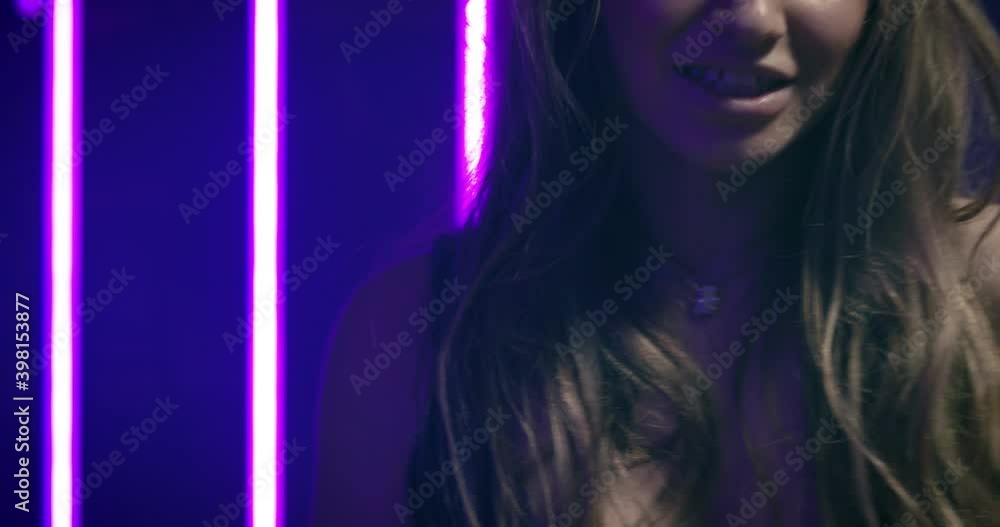Close-up of a young woman dancing energetically and looking into the camera Close-up of a young woman dancing energetically and looking into the camera