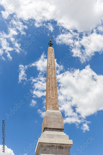 Sallustiano Obelisk against blue sky above Spanish Steps, in front of The church of the Santissima Trinità dei Monti in Rome, Italy