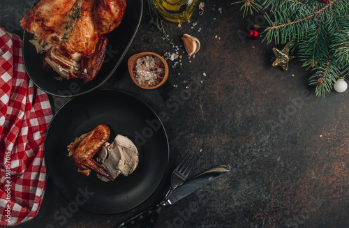 Baked chicken or turkey on a festive table with Christmas decoration. New year and Christmas concept.