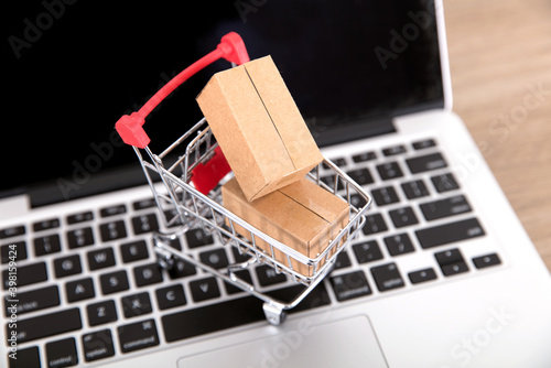 A shopping cart with express boxes on a laptop keyboard