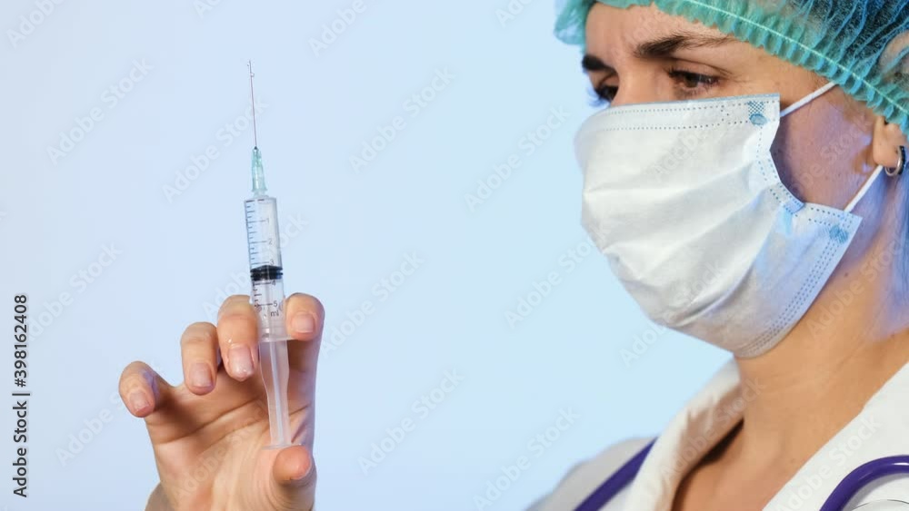 Closeup of Female Doctor with Syringe Prepares for Injection. Vaccination Against Flu and Viral Diseases, Health and Safety Concept Closeup of Female Doctor with Syringe Prepares for Injection. Vaccination Against Flu and Viral Diseases, Health and Safety Concept