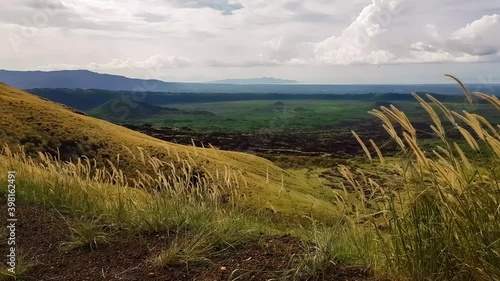 View from the mountain to the plain where the grass moves