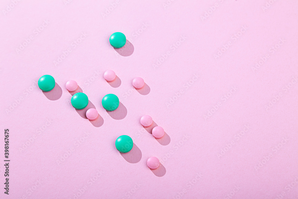 Tablets and pills, vitamins and antibiotic on pink background, copy space Tablets and pills, vitamins and antibiotic on pink background, copy space