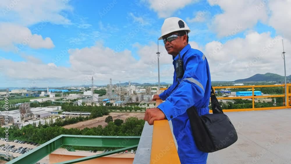 Engineers stand at the top of the plant, Oil refinery working concept Engineers stand at the top of the plant, Oil refinery working concept