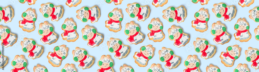Seamless pattern with Christmas gingerbread, bulls cookies isolated on light blue background. Winter baking at Xmas or New Year holiday, top view, banner Seamless pattern with Christmas gingerbread, bulls cookies isolated on light blue background. Winter baking at Xmas or New Year holiday, top view, banner