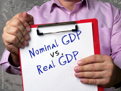 Business concept about Nominal GDP vs. Real GDP gross domestic product with sign on the sheet. photo