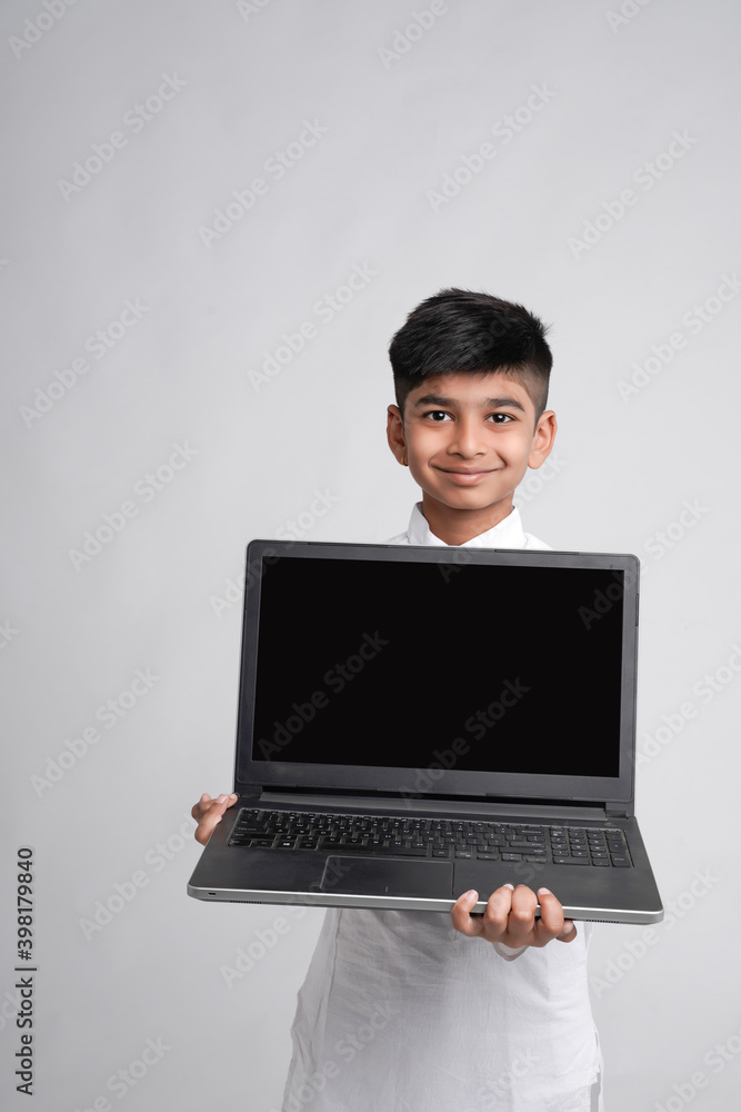 Cute indian little boy showing laptop screen Cute indian little boy showing laptop screen