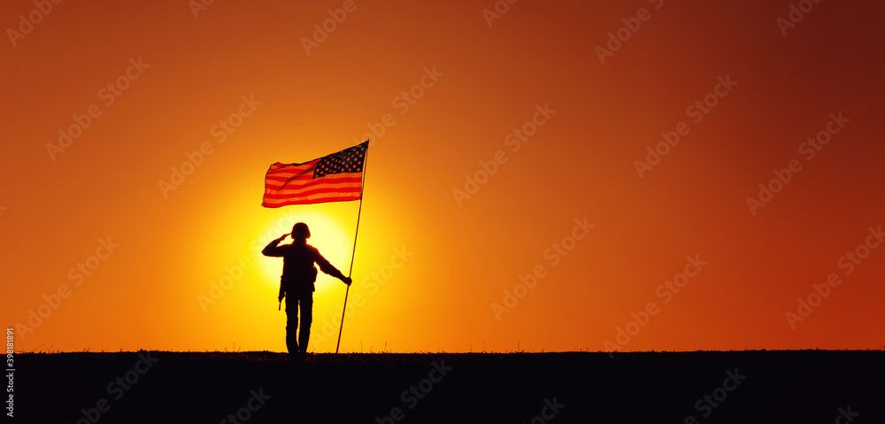 Φωτογραφία Silhouette of USA armed forces soldier, army infantryman or Marine Corps fighter saluting while standing with waving national flag on sunset background