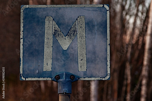 traffic sign with a capital M which means meeting place photo