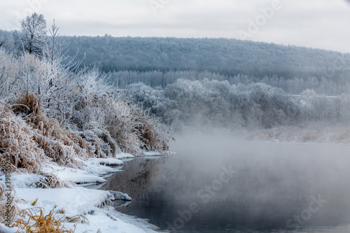 Foggy morning. There is fog on the river. Frost on tree branches and grass. © Alexander