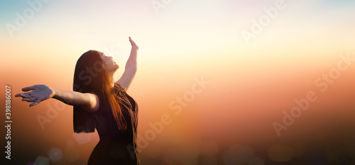 Worship God concept: Happy girl on blurred mountain sunrise background. Ai Yerweng, Bethong, Yala, Thailand, Asia