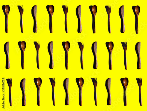 Wooden Cooking utensils on yellow background