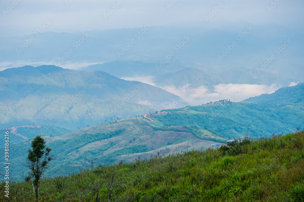 Beautiful Landscape of mountain layer in morning sun ray and winter fog at Doi Pha Hee