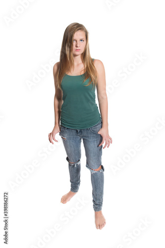 Full length portrait of a beautiful young woman wearing blue jeans and green shirt, isoltated on white studio background