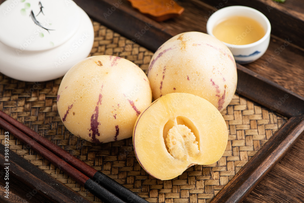 Fresh fruit ginseng fruit on the background of retro Chinese style tea plate Fresh fruit ginseng fruit on the background of retro Chinese style tea plate