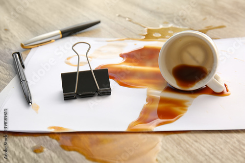 Obraz na plátně Stationery, overturned cup and spilled coffee on office table