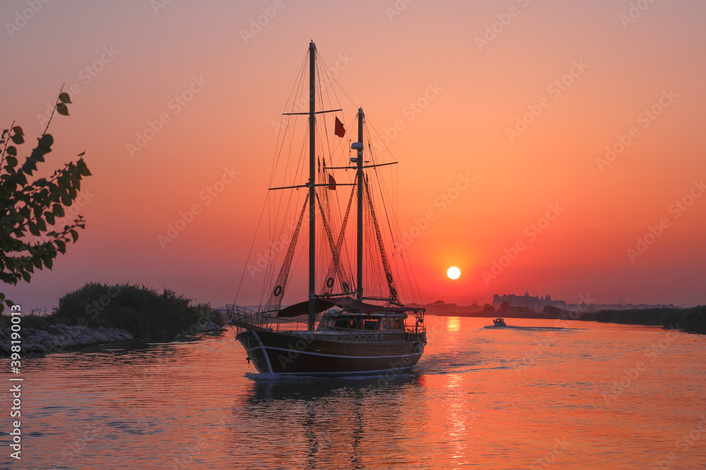 Silhouette of the ship, boat in the river at sunset, Manavgat, Antalya, Turkey