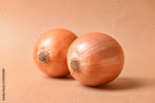 Fresh onions on color background. Erotic and female health care concept