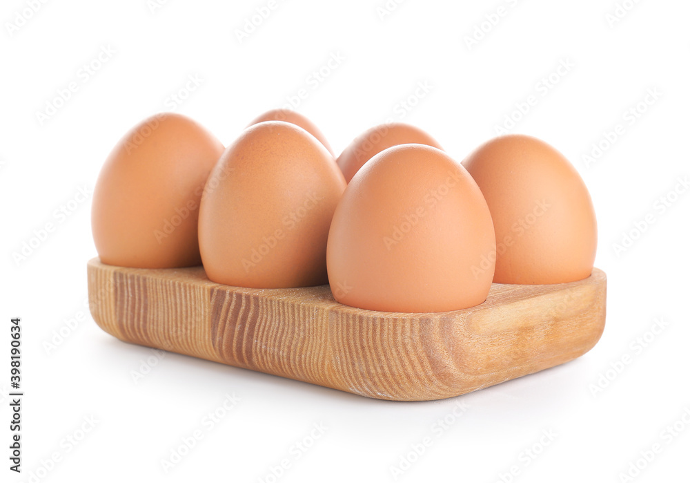 Wooden holder with chicken eggs on white background Wooden holder with chicken eggs on white background