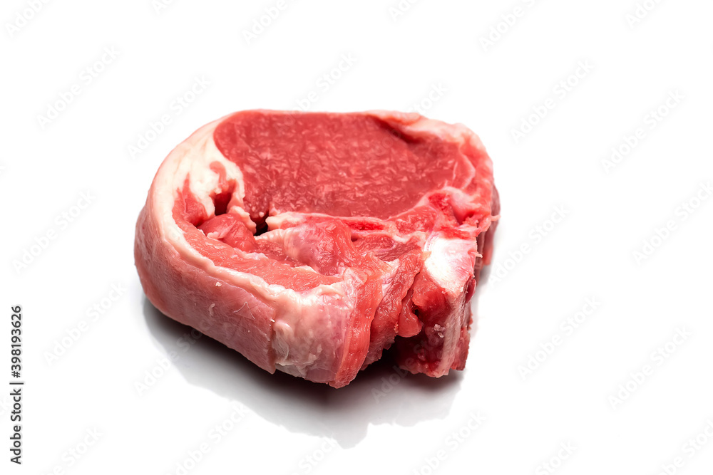 One raw lamb chop on a white isolated surface. Meat industry product One raw lamb chop on a white isolated surface. Meat industry product