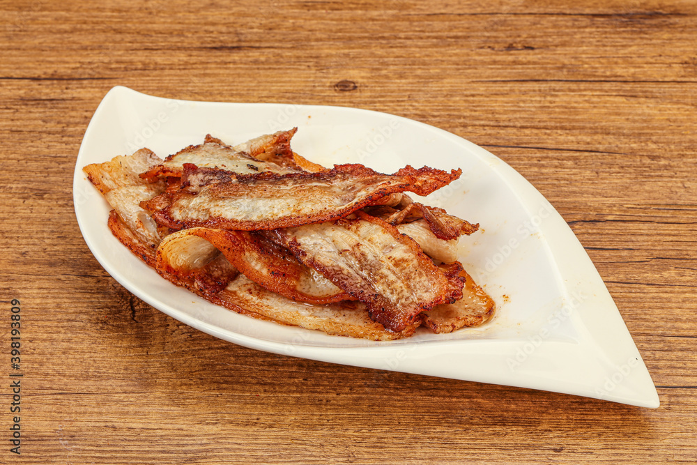 Roasted juicy bacon in the plate Roasted juicy bacon in the plate