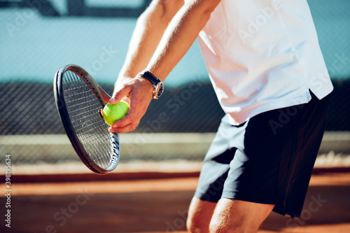 Tennis player's hand preparing to take a serve © fotofabrika