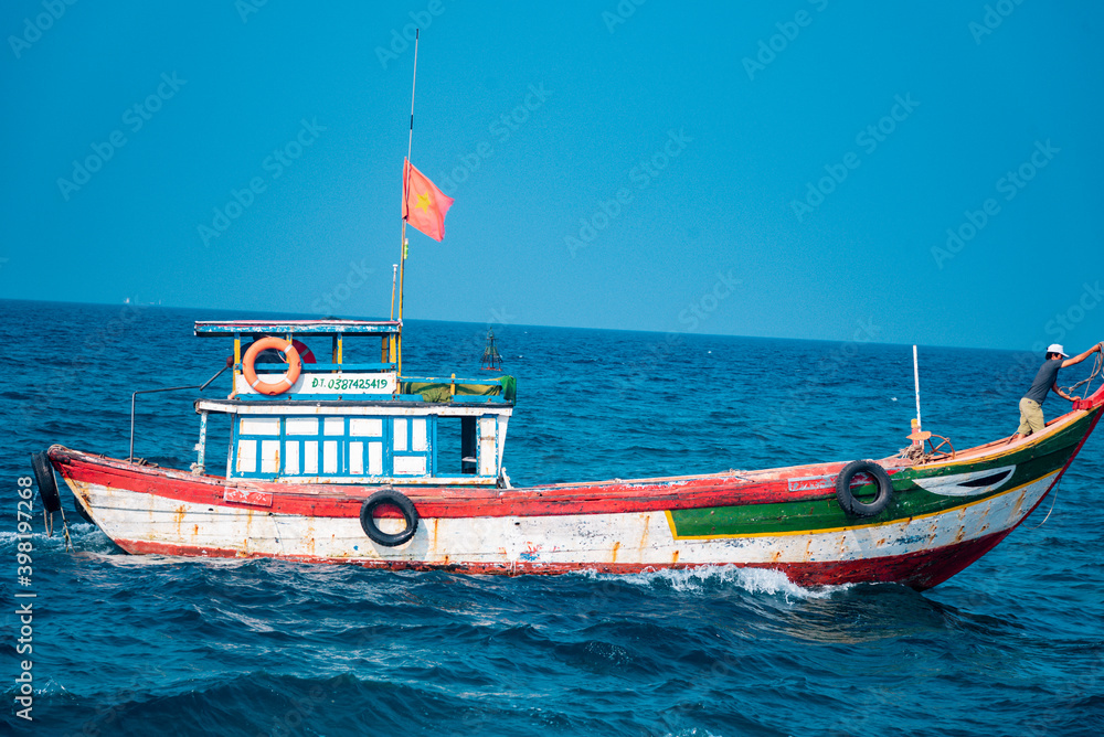 fishing boat at sea with blue sky background 
