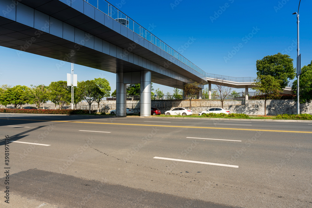 Concrete structure and asphalt road space under the overpass in the city