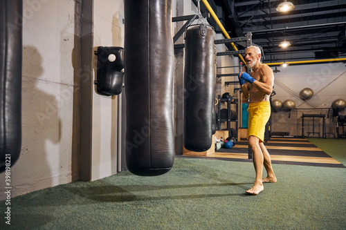 Determined male athlete starting his kickboxing workout