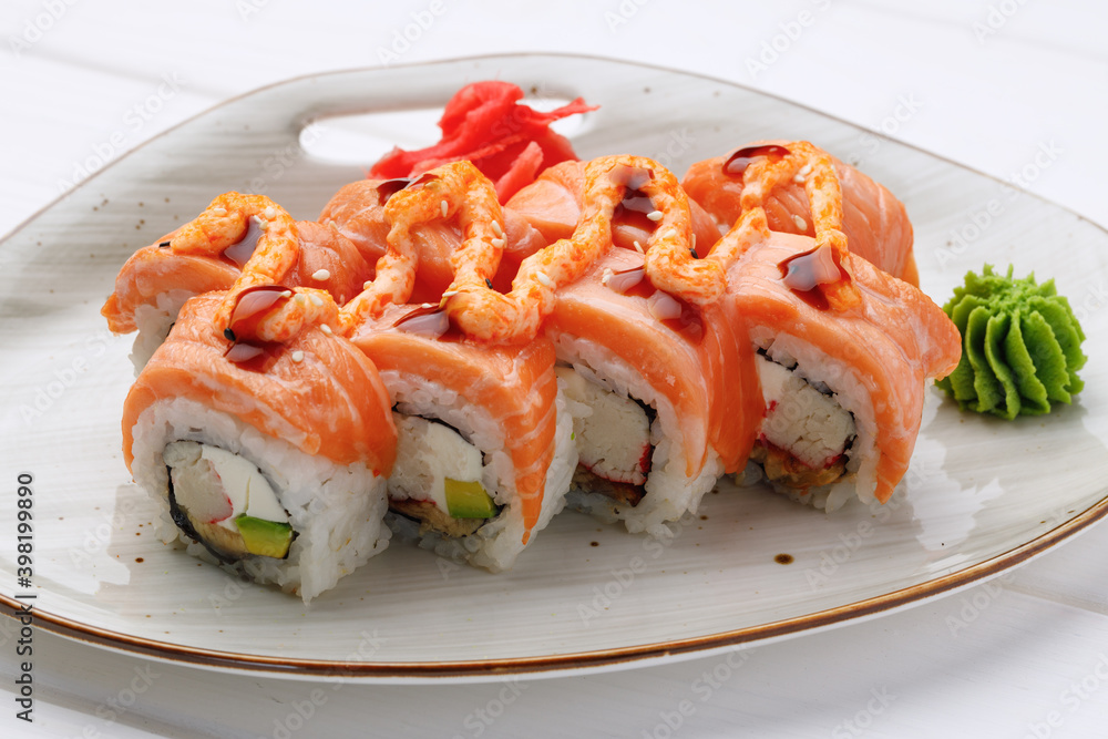 Philadelphia sushi roll served on plate on white table Philadelphia sushi roll served on plate on white table