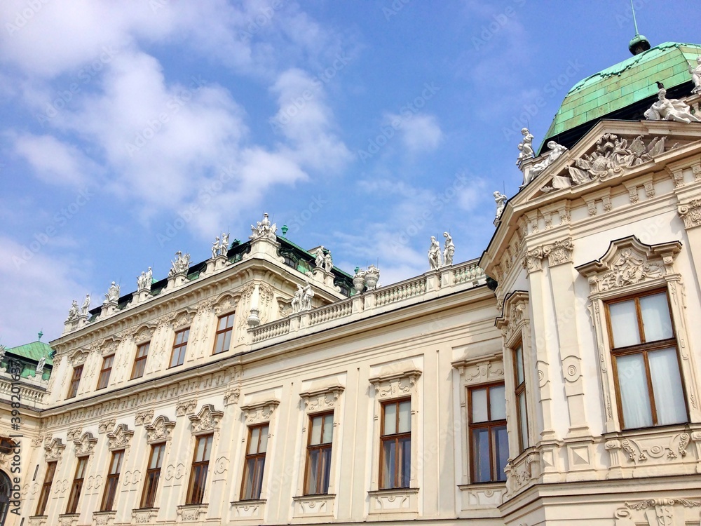 Fototapeta premium Belvedere Vienna Austria. Low angle shot of the exterior of Belvedere baroque palace against blue sky. The palace dated back to 18th century.