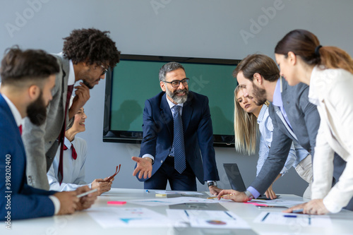 Happy success business people working, brainstoming together in office on meeting photo