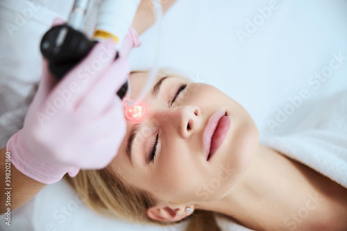 Young Caucasian woman being treated for forehead wrinkles