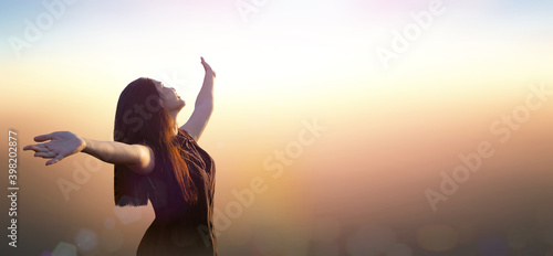 Worship God concept: Silhouette happy Asian girl on blurred mountain sunrise background. Ai Yerweng, Bethong, Yala, Thailand, Asia