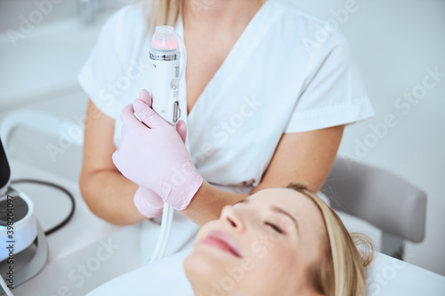 Dermatologist using the beauty equipment at work