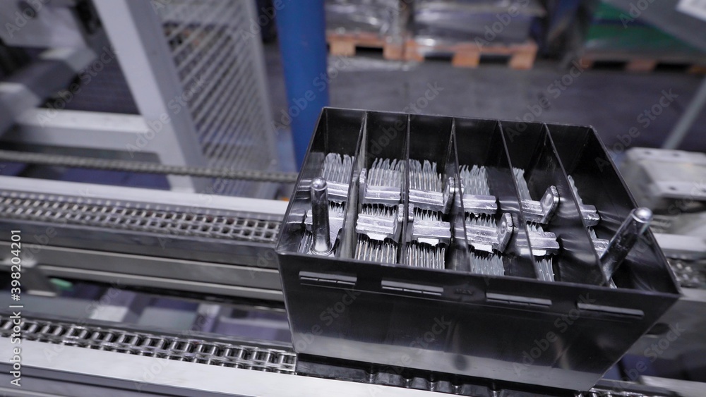 Automatic line for the assembly of car batteries. The black batteries move and collect on the conveyor belt. Automatic line for the assembly of car batteries. The black batteries move and collect on the conveyor belt.