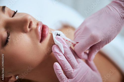 Beautiful young woman undergoing a non-surgical cosmetic procedure photo