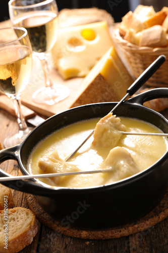 cheese fondue with wine and baguette