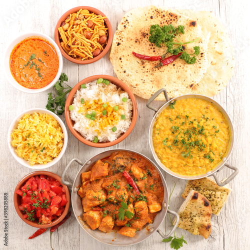 assorted of indian dish with curry dish, naan,  chicken