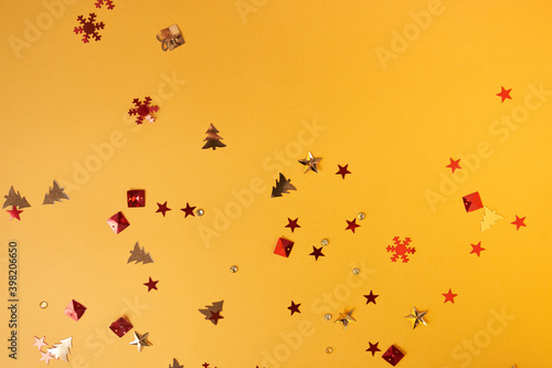 Christmas sparkles in the form of a Christmas tree, gifts, stars on a yellow background. High quality photo