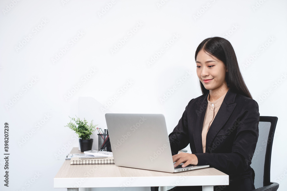 Asian businesswomen sit at their desks and calculate financial graphs showing results about their investments, plan a successful business growth process in the office Asian businesswomen sit at their desks and calculate financial graphs showing results about their investments, plan a successful business growth process in the office