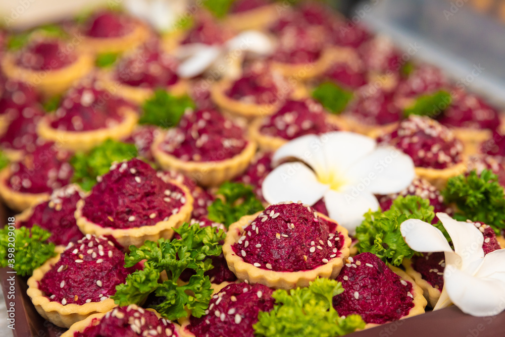 traditional russian beet salad in waffle baskets for new year decorated with sesame seeds, parsley and frangipani flowers, new year and christmas celebration in thailand traditional russian beet salad in waffle baskets for new year decorated with sesame seeds, parsley and frangipani flowers, new year and christmas celebration in thailand