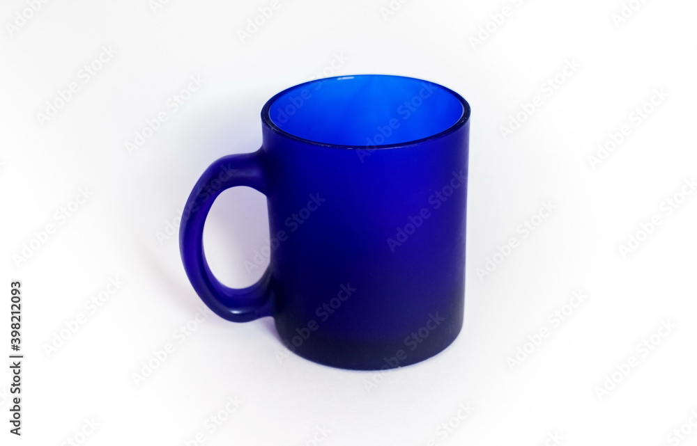 Purchased mug of blue glass closeup on a white background Purchased mug of blue glass closeup on a white background